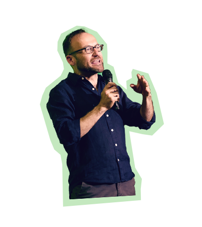 Adam Bandt speaking into a microphone